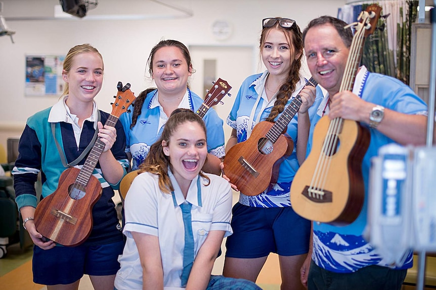 The Ukulele Angels pose with their instruments in the Cairns hospital oncology ward.