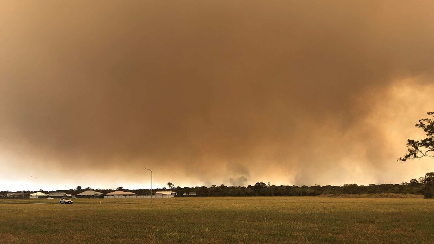 Smoke from a bushfire at Woodgate fills the sky.