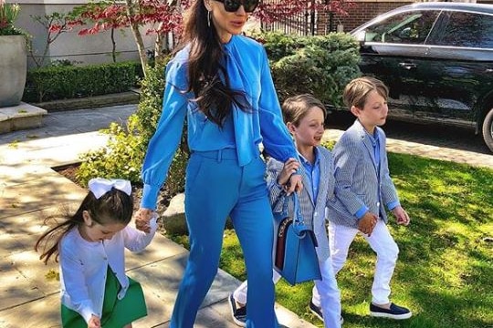 Jess Mulroney leaves the house with her three children.
