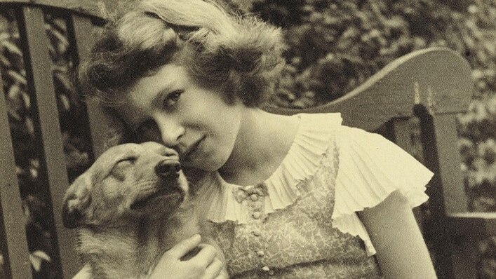 A #ThrowbackThursday photo of The Queen, then Princess Elizabeth, cuddling her corgi Dookie.