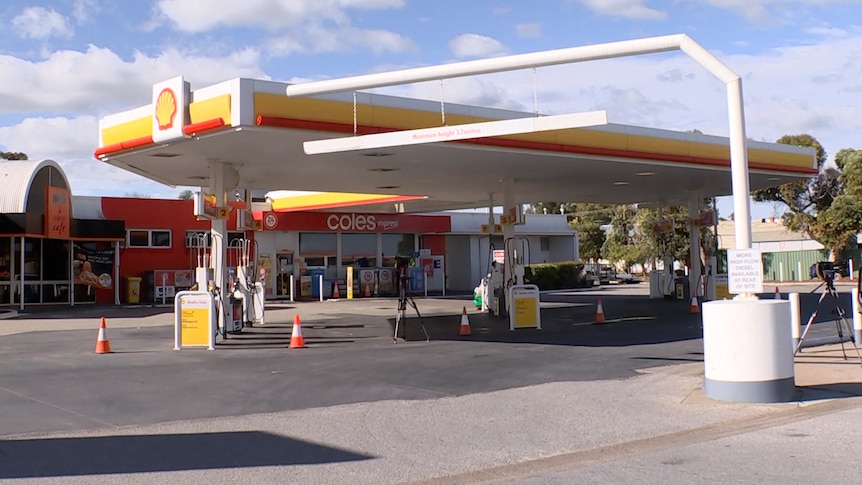 A petrol station with a Shell symbol on it
