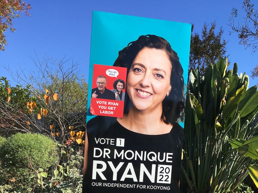 A yard sign for independent candidate Monique Ryan is partially covered with a red sticker.