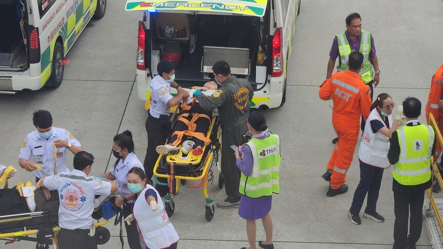Emergency services attend to injured passengers on the tarmac. 