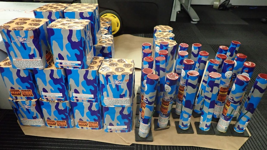 Fireworks tubes and cartons in a group on the floor