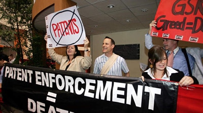 AIDS activists carry placards and banners during a protest.