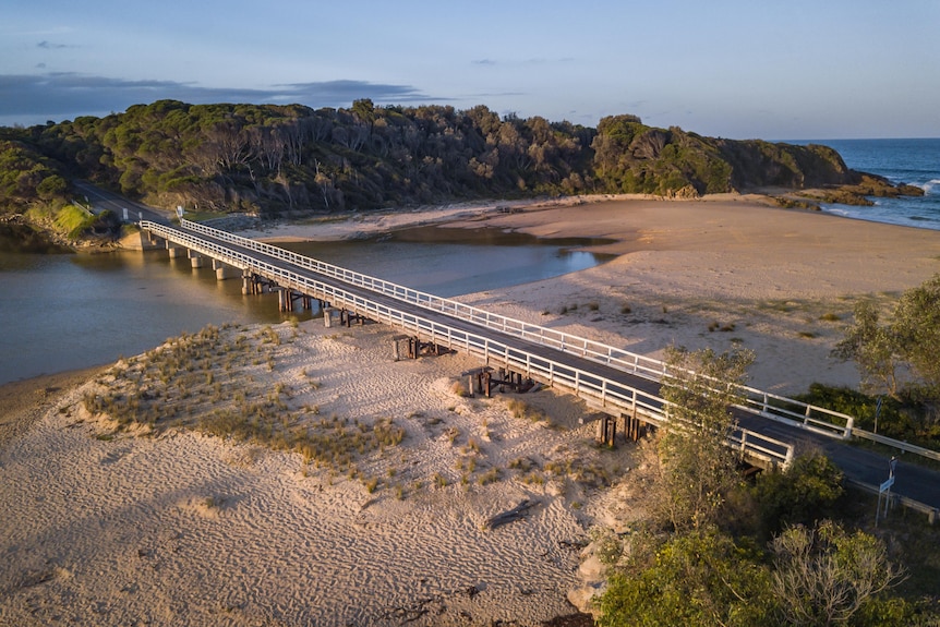 a drone shot of a wooden bridge