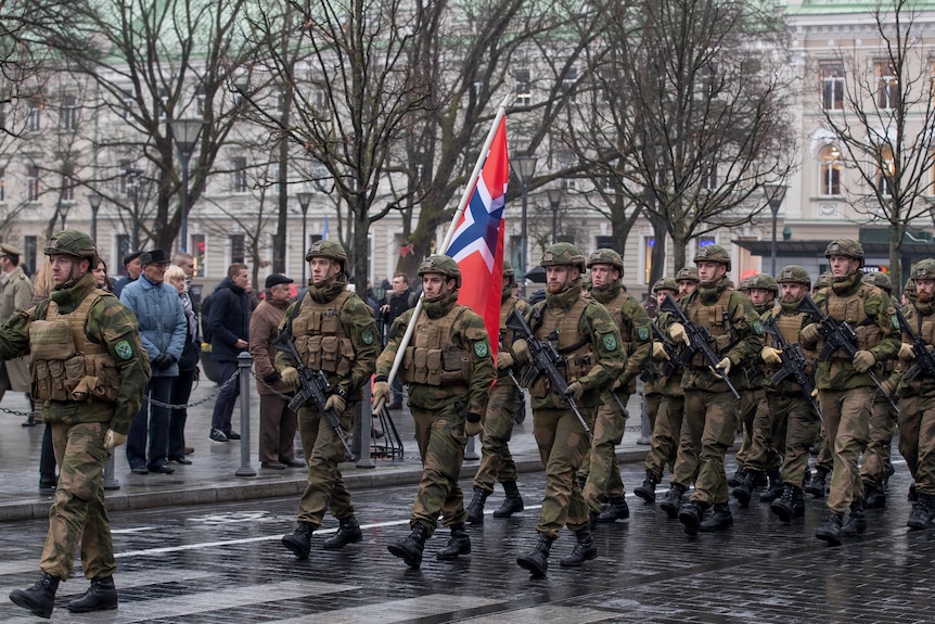 Norwegian soldiers march with their flag in Lithuania's Army Day parade in this 2017 photo.