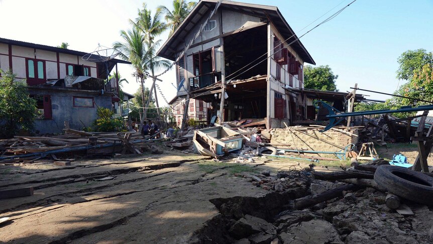 People inspect houses that were badly damaged by an earthquake in the village of Ma Lar at Kyauk Myaung township, Myanmar.