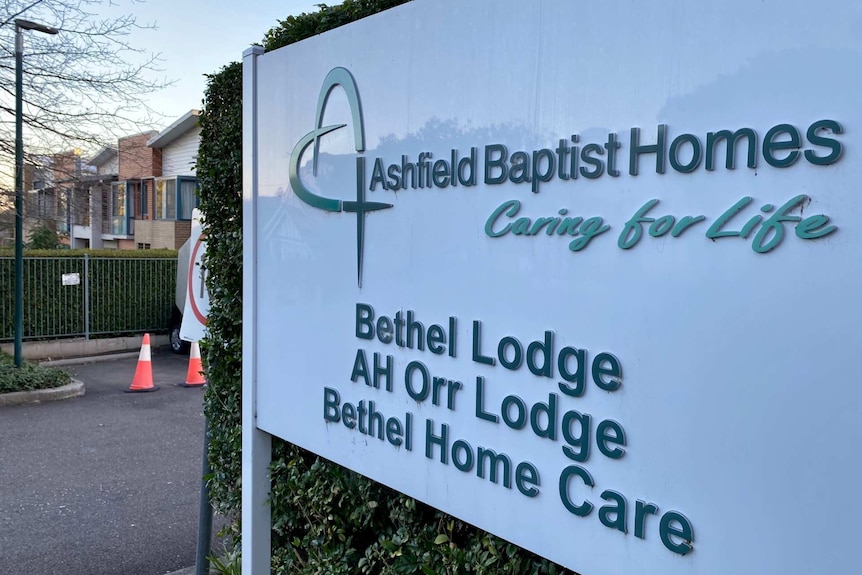 a sign outside a parking lot that reads ashfield baptist homes
