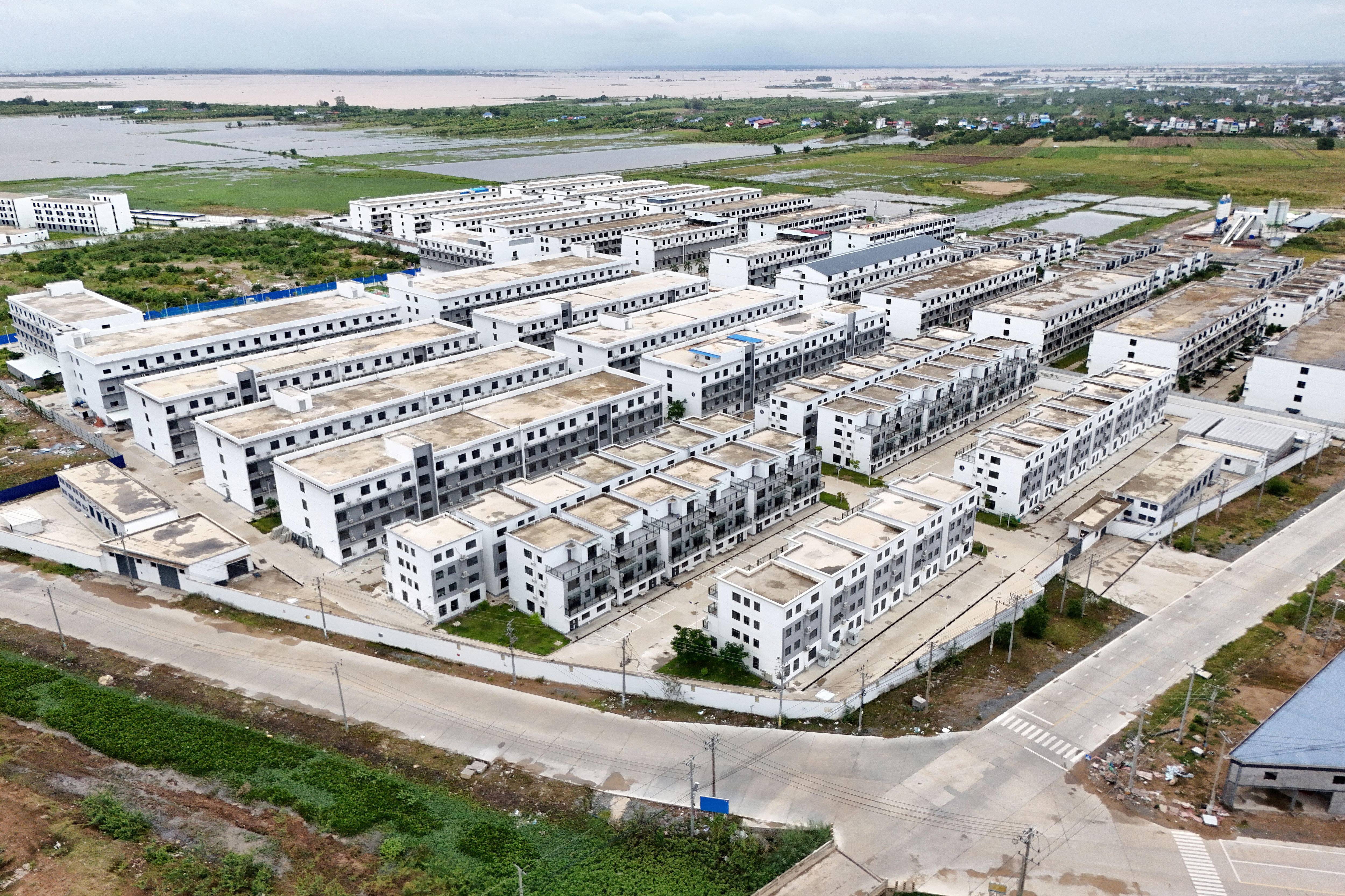 An aerial view shows rows of multi-storey buildings.
