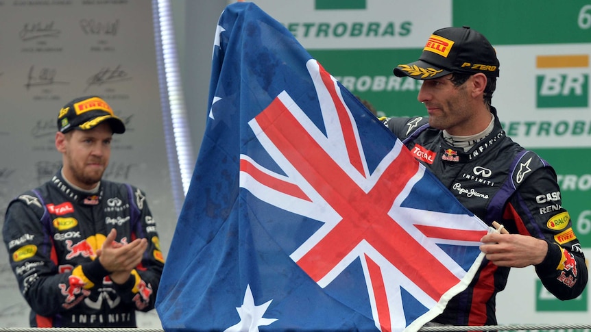 Man holding Australian flag on a podium.