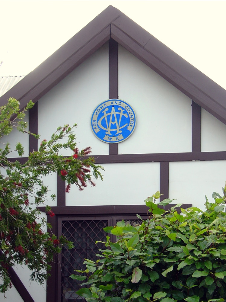 Front facade of CWA house with badge on the gable