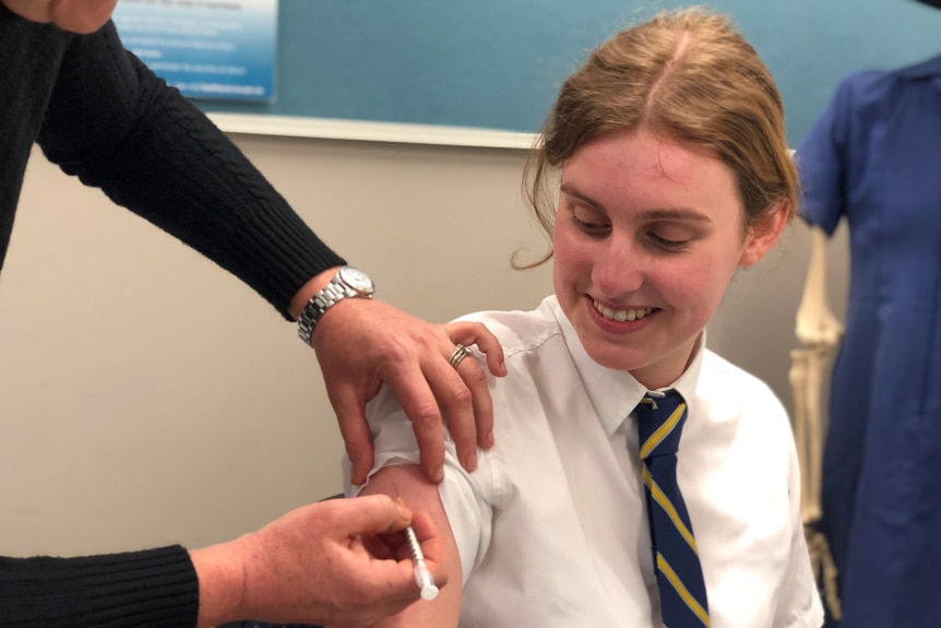 School student receiving COVID-19 vaccine