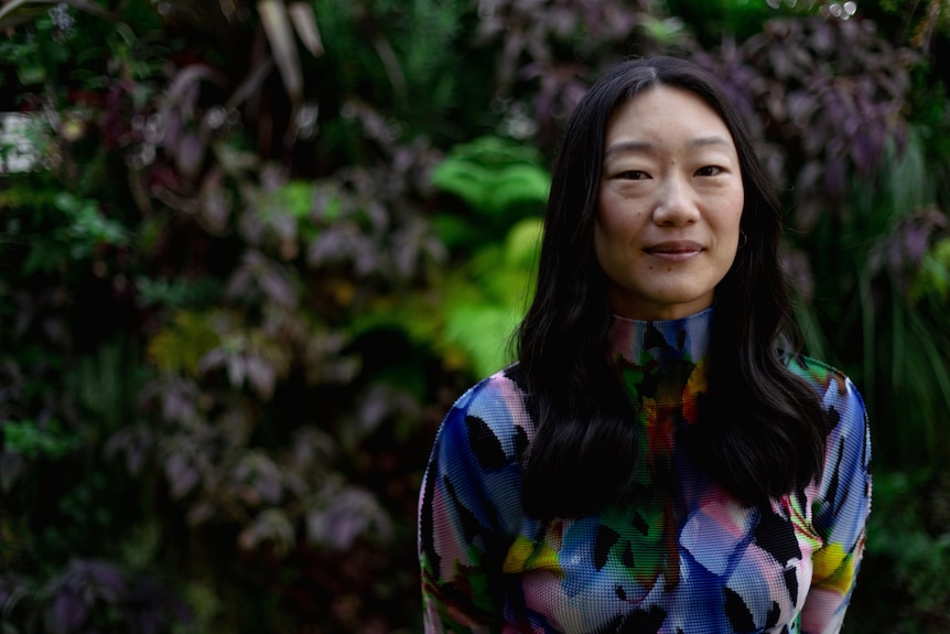 A South Korean Australian woman looks directly at the camera
