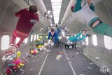 A screenshot from the OK Go video Upside Down & Inside Out shows band members floating in zero gravity