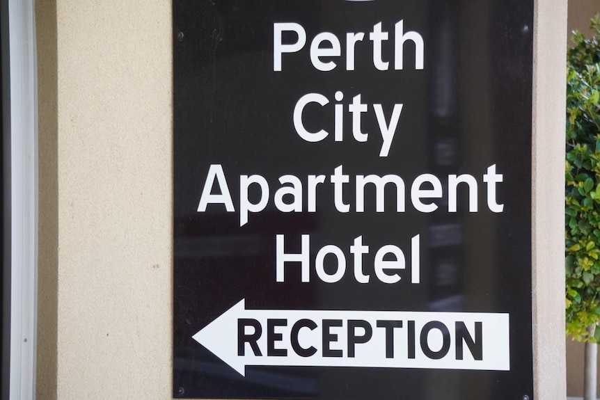 A black and white sign outside Perth City Apartment Hotel.