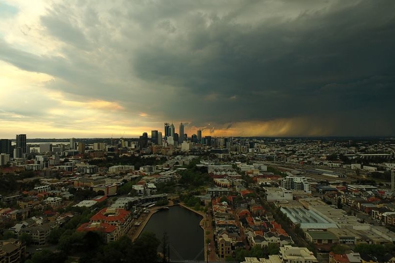 Heavy, dark clouds over Perth city centre at sunset