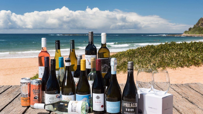 An assortment of wines sit on a deck.