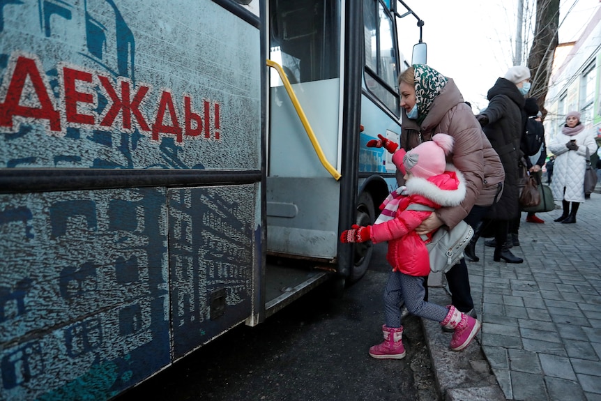 People board a bus during the evacuation of east Ukrainian residents to Russia