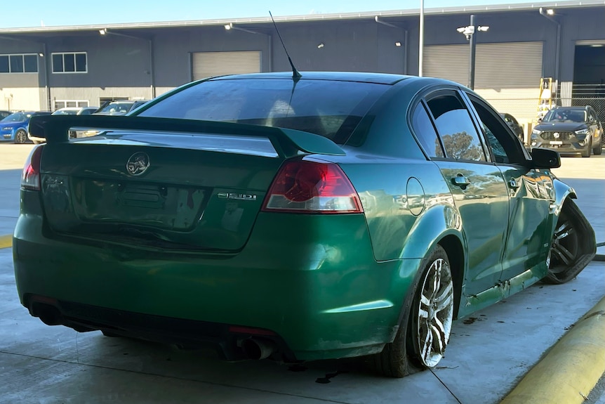 A green Holden Commodore.