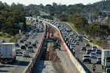Work is carried out on the widening of the Pacific Highway near springwood, south of Brisbane, Monday, June 24, 2013.