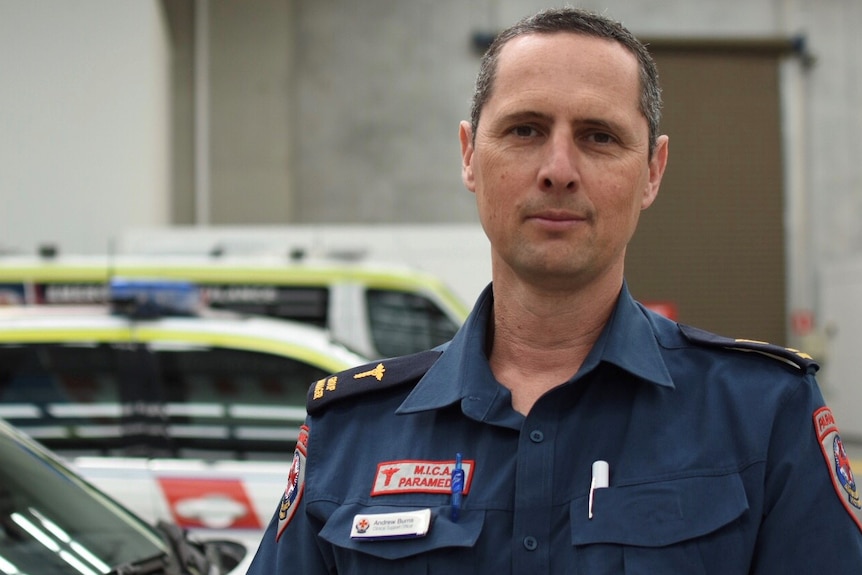 Intensive care paramedic Andrew Burns in front of a mobile intensive care unit.