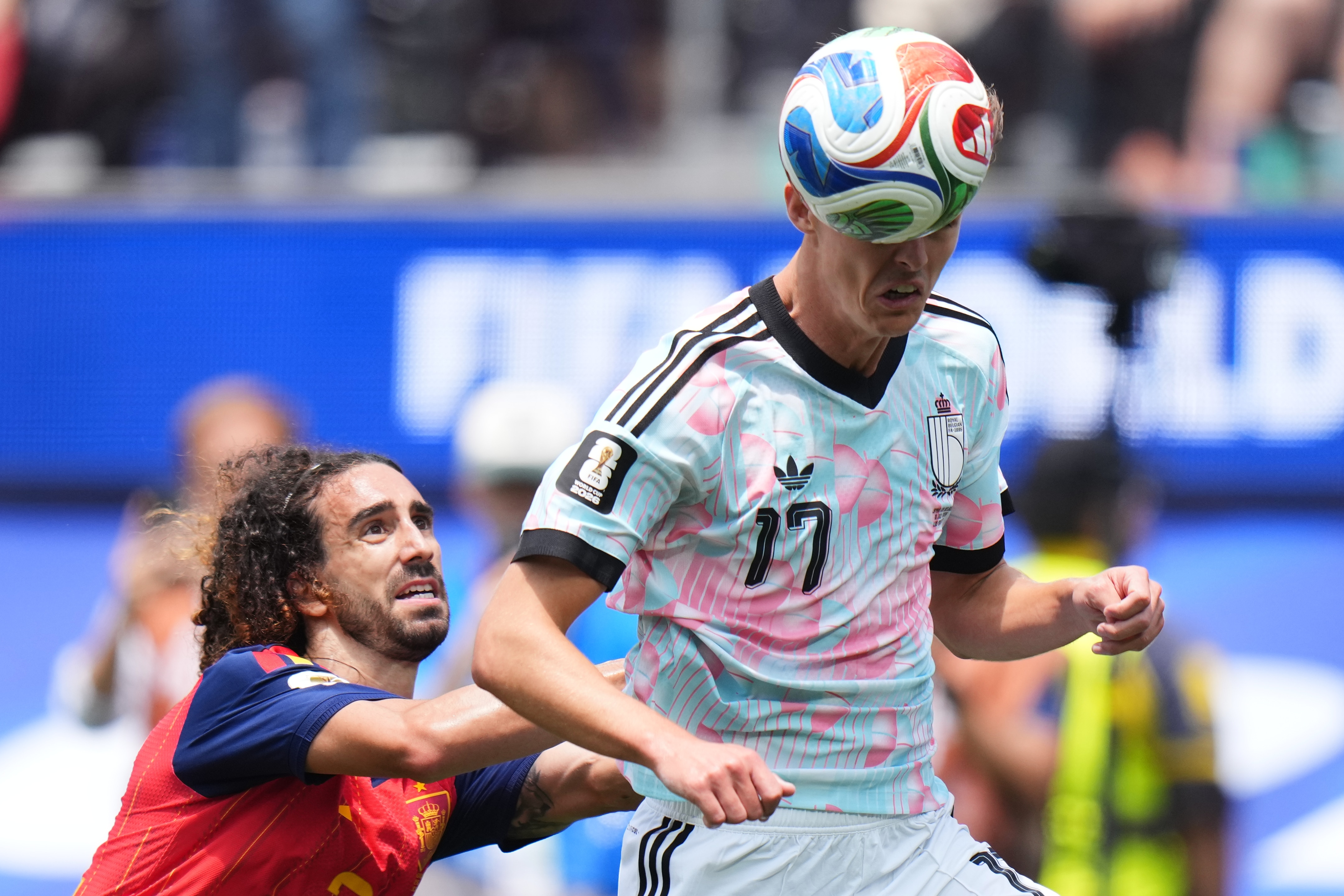 Charles De Ketelaere heads the ball under pressure from Marc Cucurella
