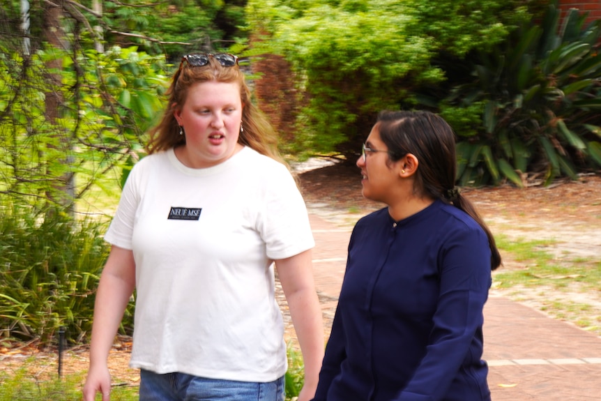 Jess Rolland and Mansi Matoo walk and talk together at Curtin University.