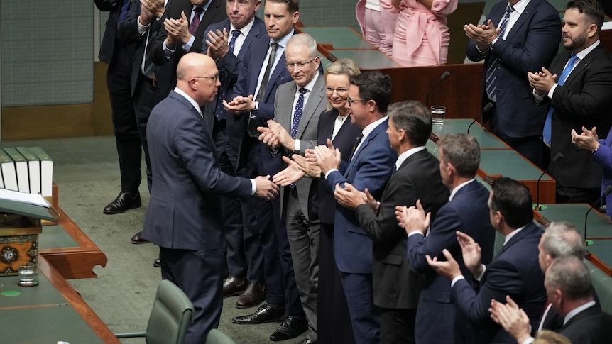 Peter Dutton shakes hands with colleagues in the House of Representatives. 