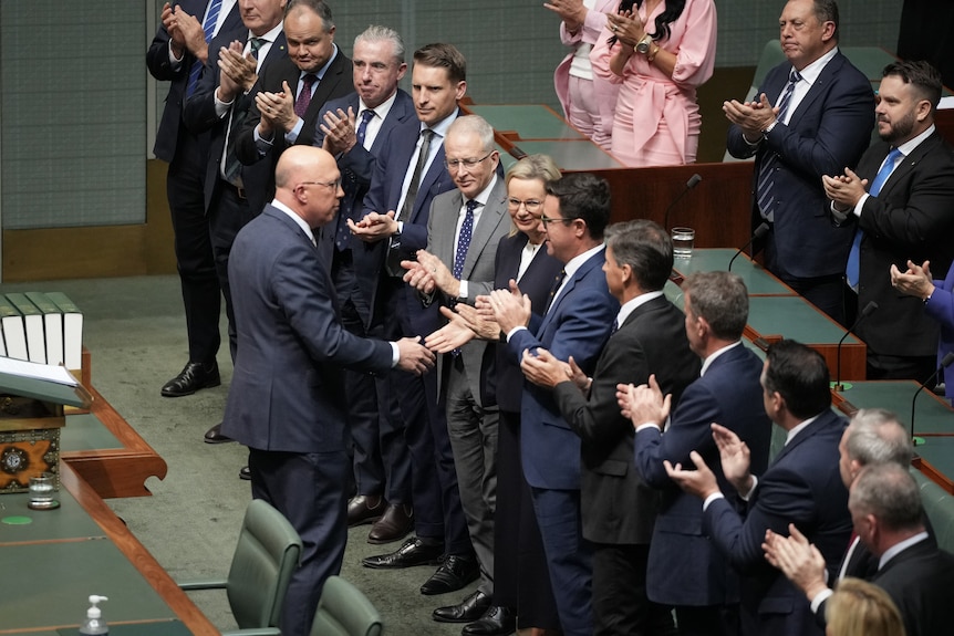 Peter Dutton shakes hands with colleagues in the House of Representatives. 