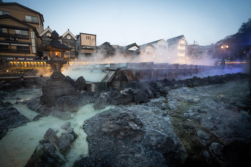 Steam rising off a hot spring in a Japanese village