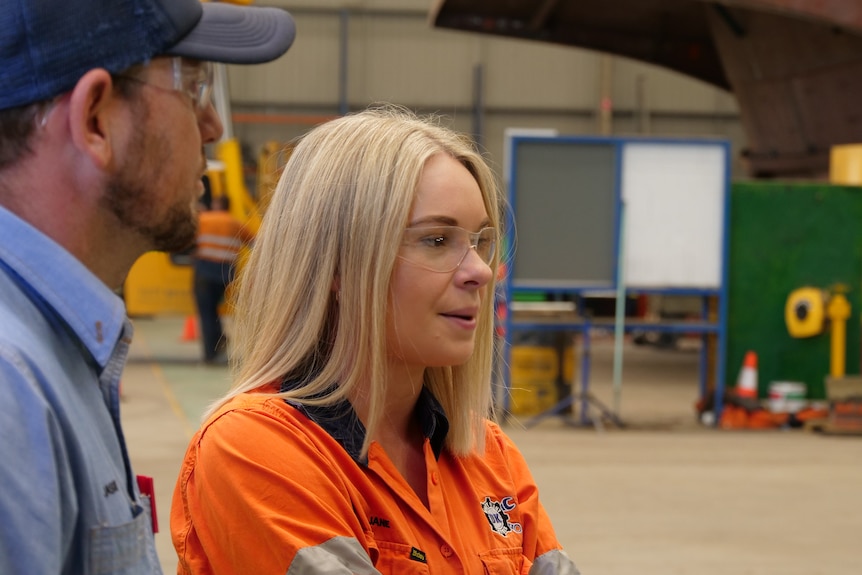 A blonde woman in high visibility clothing