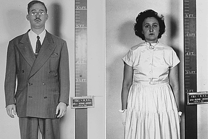 Julius and Ethel Rosenberg stand by measuring tapes for mugshot.