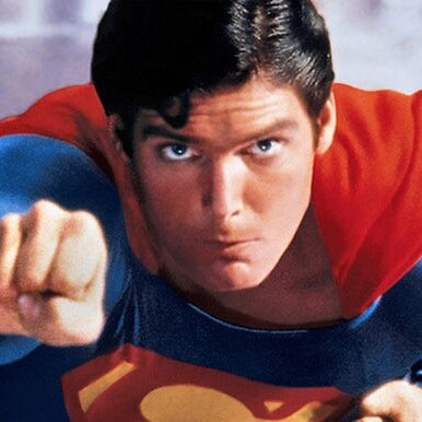 Christopher Reeve as superman, flying through the air