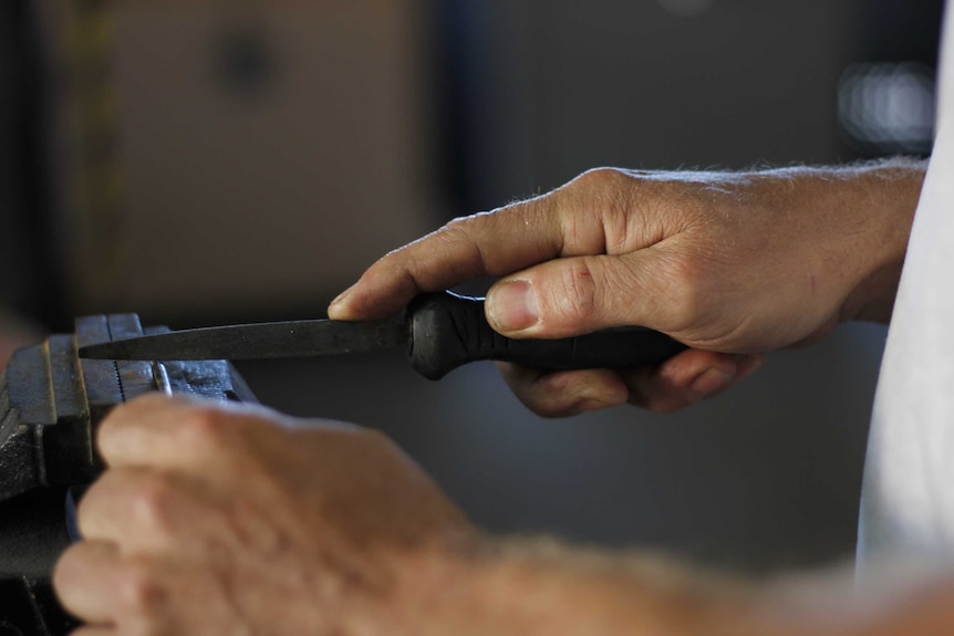 Close up of a locksmith working.