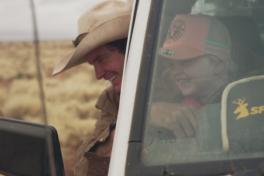 Brook McGlinchey with his daughter Hayley hopping out of their ute