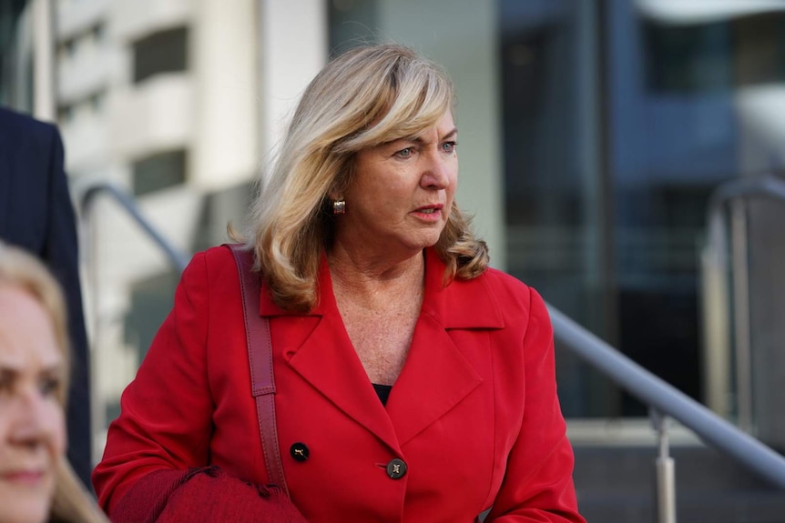 Ms Martin walks down the steps of the District Court.