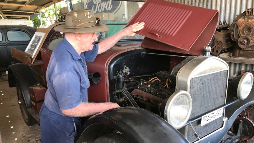 Man looks under hood of 1925 Ford Model T