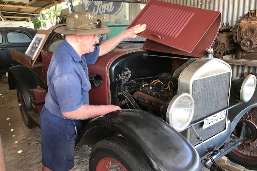 Man looks under hood of 1925 Ford Model T