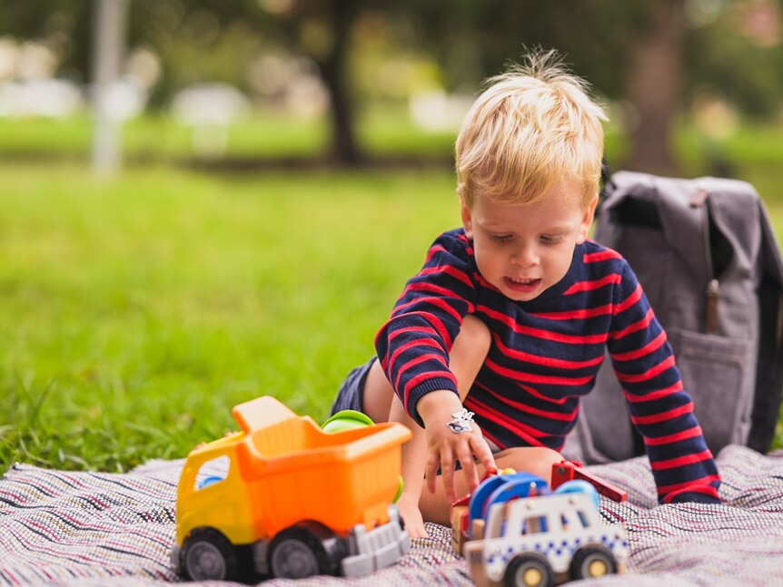 A child plays with a toy dumptruck.