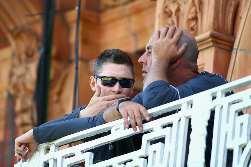 Looking for answers ... Michael Clarke (L) and Darren Lehmann chat during day two