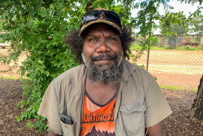 Gabby Gumurdul, a traditional owner, standings in front of a tree in Gunbalanya, NT.