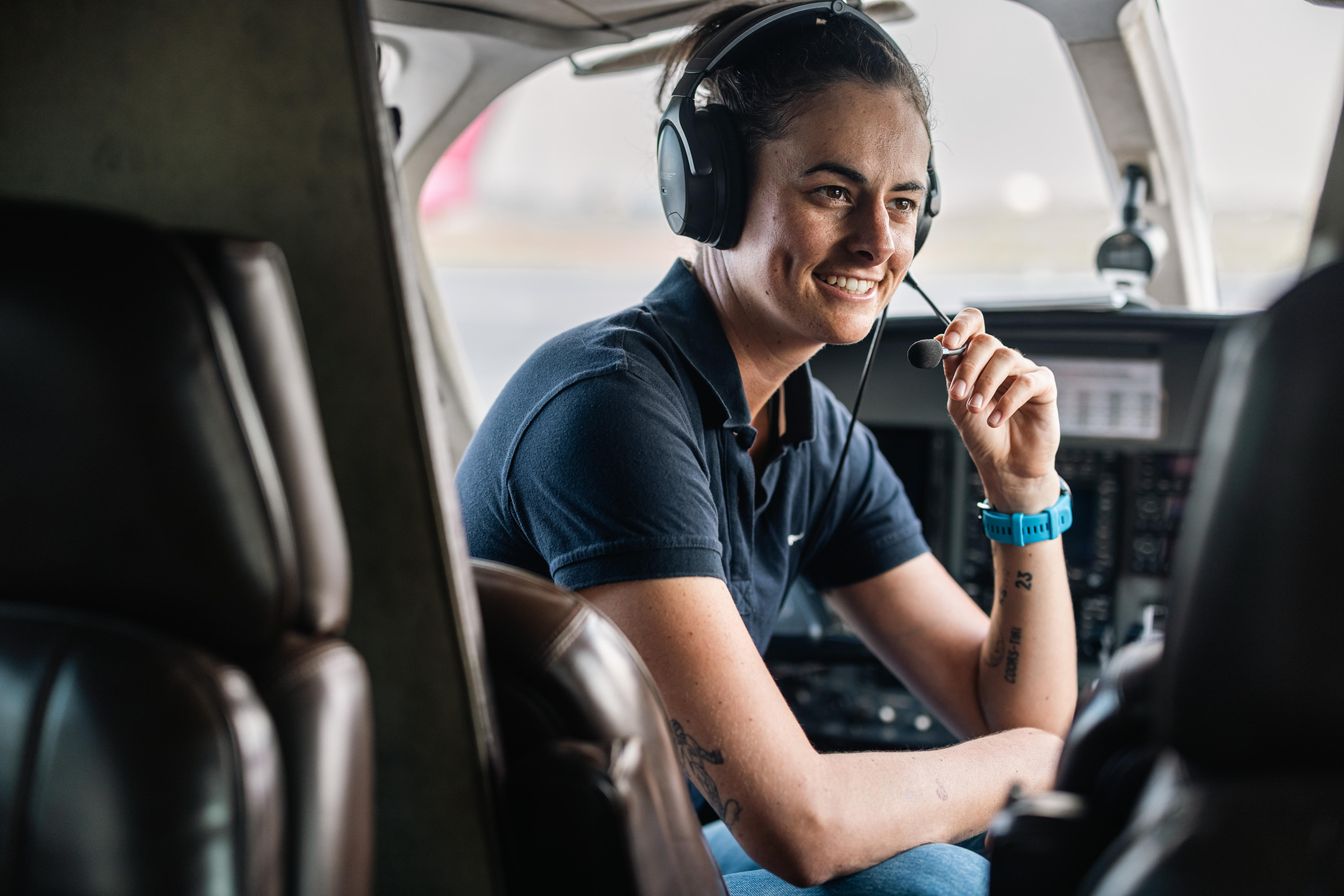 Kelly Shotten sits in the cockpit of an aircraft