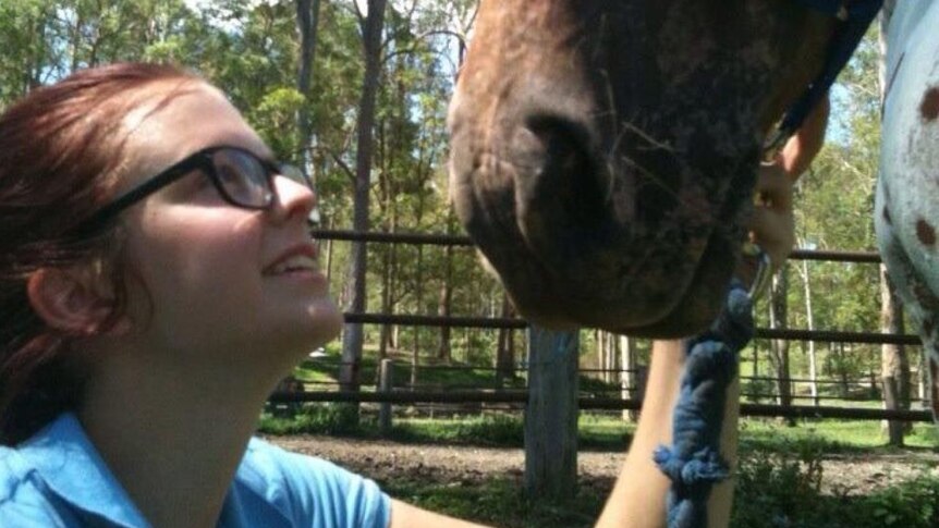 Chelsea patting a horse