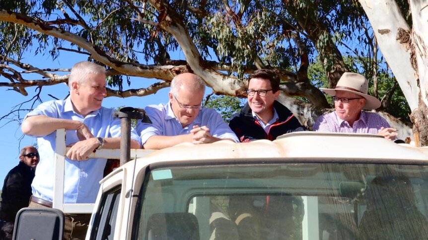 The Prime Minister on the back of a ute on a Dubbo farm during the election campaign.