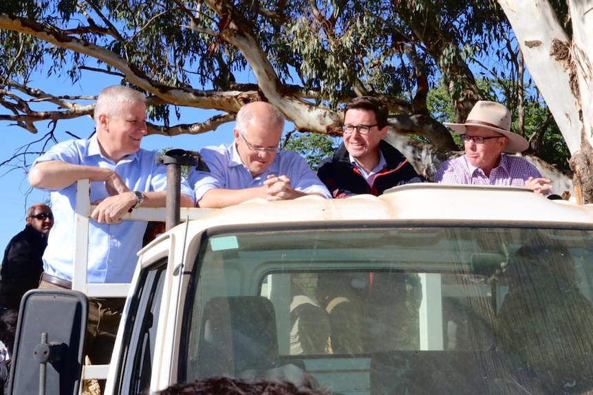 The Prime Minister on the back of a ute on a Dubbo farm during the election campaign.