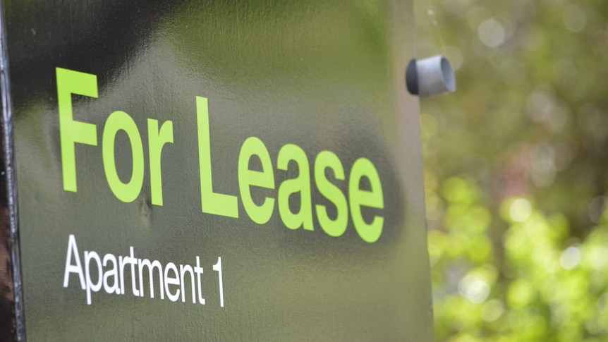 A black sign with green letters reading "For Lease, Apartment 1".