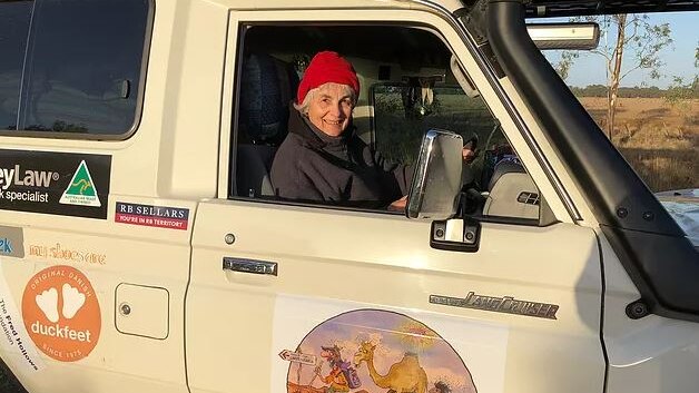 Susan McDonald sitting inside the 4wd support vehicle and smiling.