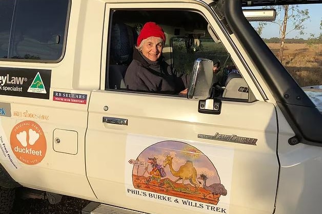 Susan McDonald sitting inside the 4wd support vehicle and smiling.