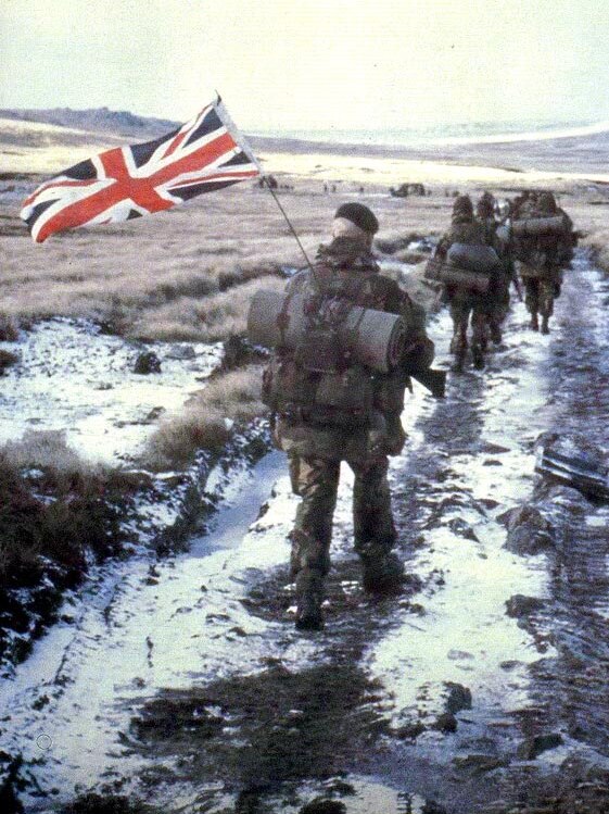 British soldiers walk through the Falkland Islands during the Falklands War. (www.militaryphotos.net)